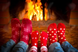 47423034-Family-relaxing-at-home-Feet-in-Christmas-socks-near-fireplace-Winter-holiday-concept-Stock-Photo